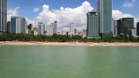 wide-aerial-panoramic-city-view-of-Nha-Trang-coastline-in-Khanh-Hoa-province-Vietnam-during-a-sunny-summer-day-with-many-tall-buildings-along-the-white-sand-beach