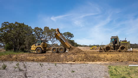 Time-lapse-of-road-rollers-and-a-dump-truck-constructing-the-soil-base-of-a-new-housing-development-road