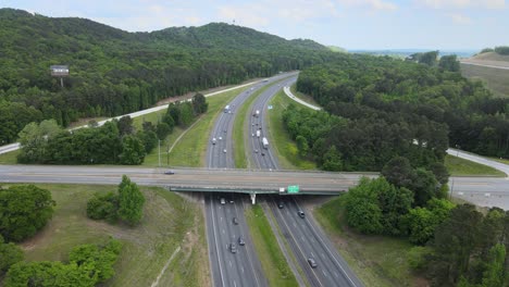 Flying-over-an-interstate-with-an-overpass-as-the-highway-curves-off-into-the-distance