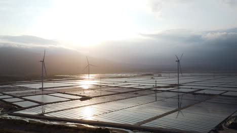 Circle-view-of-salt-fields-and-wind-turbines,-outside-city-of-Phan-Rang