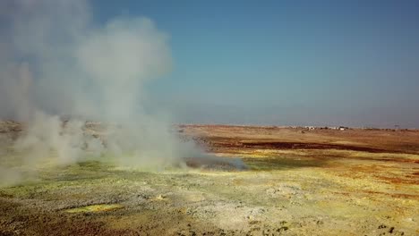 Hot-steam-is-going-from-hydrothermal-field-in-Danakil-Depression-caused-by-tectonic-plates-in-Africa---aerial-reveal-of-natural-wonder