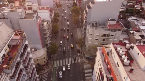 Dynamic-movement-of-cars-in-perfect-lanes-amidst-tall-buildings-on-Cordoba-Avenue-in-Buenos-Aires,-Argentina