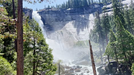 A-man-takes-a-picture-of-the-misty-waterfall-in-Yosemite-National-Park