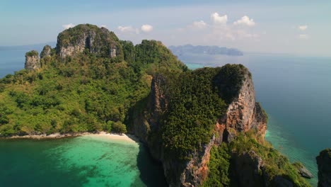 aerial-drone-panning-right-over-Ko-Kai-surrounded-by-pristine-white-sand-beaches-and-lush-forest-in-tropical-Krabi-Thailand-with-turquoise-blue-ocean-on-a-sunny-day