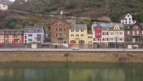 static-shot-of-the-river-banks-with-beautiful-old-houses-with-their-typical-facades-in-the-incredibly-beautiful-german-town-of-cochem-stretching-over-the-river-Moselle
