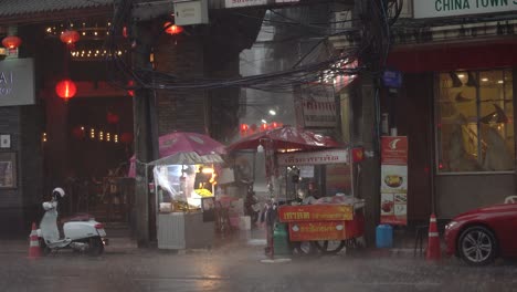 Monsoon-downpour,-streets-of-Chinatown,-Bangkok.-Evening-scene