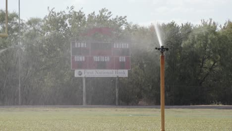 Sprinkler-head-spraying-water-on-a-Texas-High-School-football-field-Friday-Night-Lights