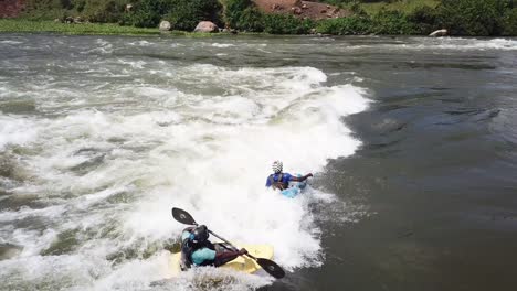 3-kayakers-descending-the-swift-waters-of-the-Nile-River-in-Jinja,-Uganda