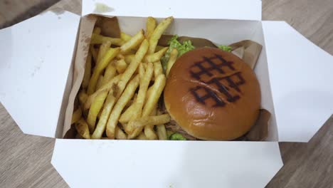 the-shot-of-burger-with-fries-in-the-paper-box