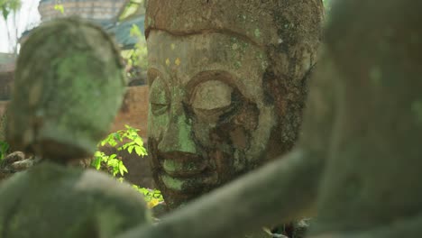 4K-Cinematic-slow-motion-footage-of-ruins-of-Buddhist-statues-at-Wat-Umong-Temple-in-Chiang-Mai,-Northern-Thailand-on-a-sunny-day