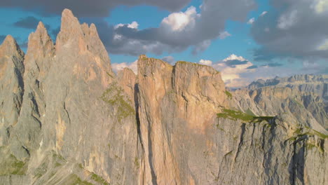 Aerial-view-flying-across-stunning-sunlit-Seceda-South-Tyrol-green-slope-mountain-ridge
