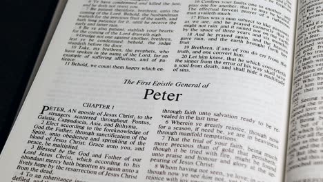Close-Up-Shot-of-Bible-Page-Turning-to-the-book-of-First-Peter