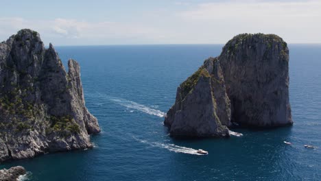 Yachts-Boating-around-the-Faraglioni-Sea-Stack-Rock-Formations-in-Italy