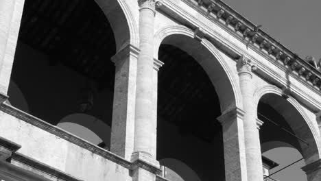 Black-and-white-shot-of-Palazzo-Venezia-from-below-in-Rome,-Italy-at-daytime