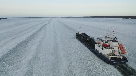 Aerial-tracking-view-of-oil-and-chemical-tanker-CRYSTALWATER-call-sign-ESLI-moving-ahead-in-ice-covered-Finnish-archipelago