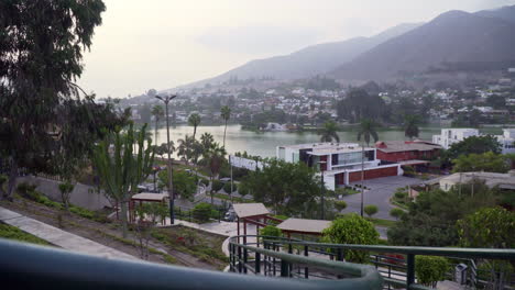 Stabilized-sliding-shot-from-left-to-right-looking-over-the-town-in-Las-Lagunas,-La-Molina,-Lima,-Peru