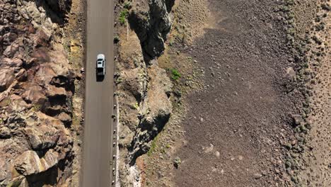 Top-down-shot-of-a-truck-driving-on-a-rocky-highway