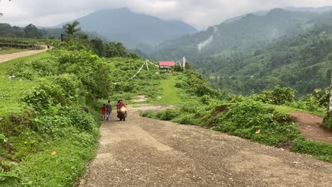 Two-brothers-walking-near-India-Bhutan-border-at-Jhalong-,-Dooars---West-Bengal-,-India