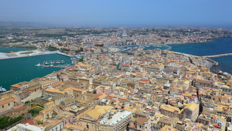 Wide-drone-shot-of-Syracuse-coastline,-historic-city-on-the-Italian-island-of-Sicily