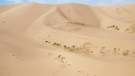 Aerial-dolly-of-sand-dune-and-blue-sky-in-gobi-desert-in-sunny-daytime