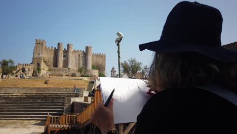 Woman-sketching-a-medieval-castle