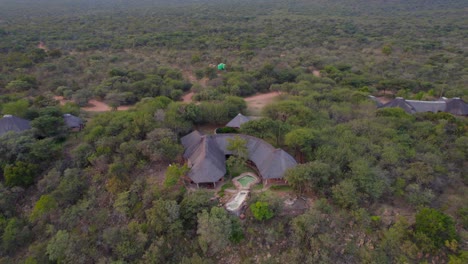 Luxurious-African-rural-lodge-with-pool-in-middle-of-bush-in-green-savannah