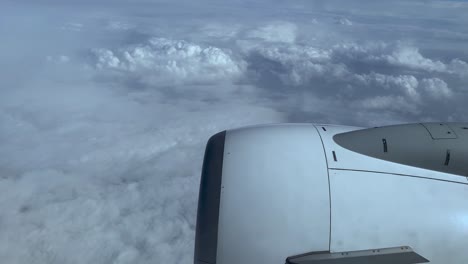 Traveling-Airplane-With-View-Of-Its-Engine-And-The-Cloudy-White-Sky-In-Porto,-Portugal