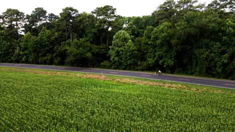 Drone-following-along-with-a-couple-as-they-leisurely-bicycle-the-countryside-near-the-Great-Dismal-Swamp-National-Wildlife-Refuge