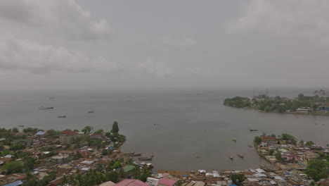 Aerial-flyover-of-a-bay-that-is-off-of-downtown-Freetown,-Sierra-Leone