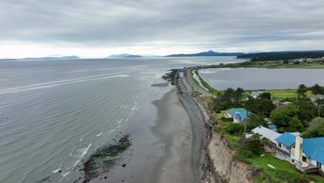 Aerial-view-showing-the-end-of-the-bluff-on-Whidbey-Island's-West-Beach-with-the-ocean-and-the-San-Juan-Islands-off-in-the-distance