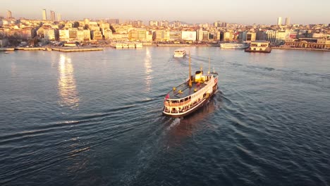 Majestic-aerial-showcasing-ferries-crossing-the-Bosphorus-Strait-in-Istanbul,-Turkiye-at-sunset