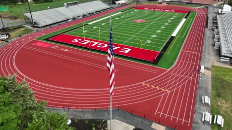 Football-field-and-American-flag-at-high-school-track