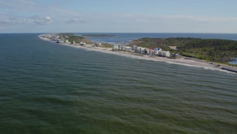 Aerial-flight-from-the-Gulf-Coast-towards-beach-front-homes-along-a-Florida-peninsula