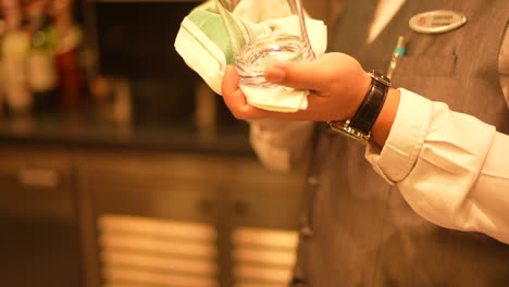 waiter-cleaning-a-wine-glass-in-restaurant
