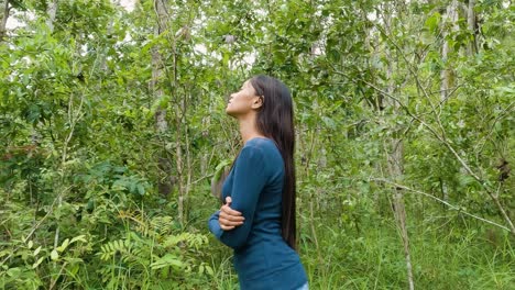 Young-Woman-With-Long-Black-Hair-Breath-In-The-Forest