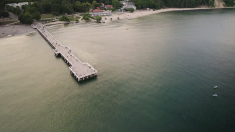 4k-drone-footage-of-Gdynia-Orlowo-jetty-in-the-sea-at-a-sandy-beach