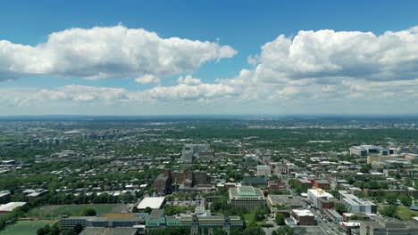 4K-Cinematic-urban-landscape-footage-of-a-drone-flying-around-the-Observatory-Saint-Joseph-in-Montreal,-Quebec-on-a-sunny-day,-behind-Mount-Royal-capturing-a-beautiful-panoramic-view