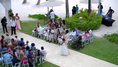 Flower-girl-drops-rose-petals-entering-wedding-ceremony-at-outdoor-gazebo-in-tropical-resort-destination