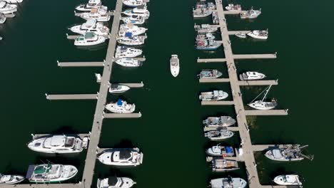 Overhead-aerial-shot-of-a-boat-returning-to-the-marina-on-a-warm-sunny-day