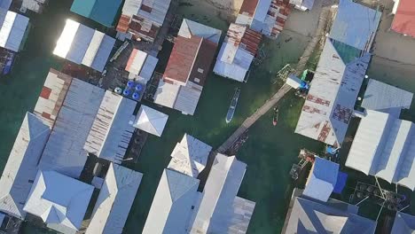 Aerial-flight-over-local-village-in-Malaysia,-birds-eye-perspective-moving-forward-in-slow-motion