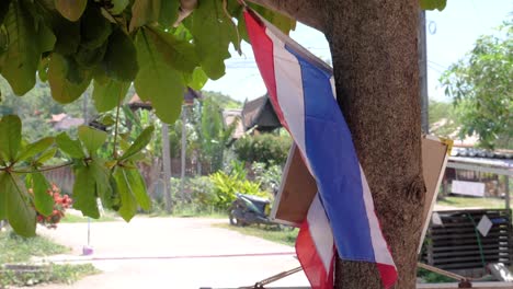 Flag-of-Thailand-hanging-outside-on-sunny-day-in-Thailand---ultra-slow-motion