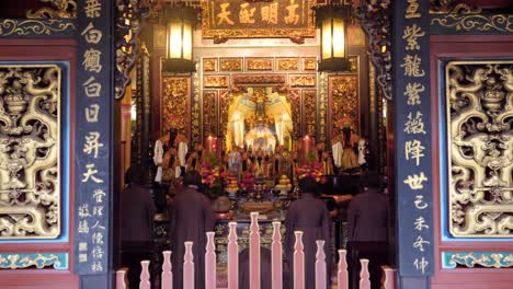 Slow-motion-shot-of-religious-women-praying-together-at-Dalongdong-Baoan-Temple-in-Taipei,-Taiwan