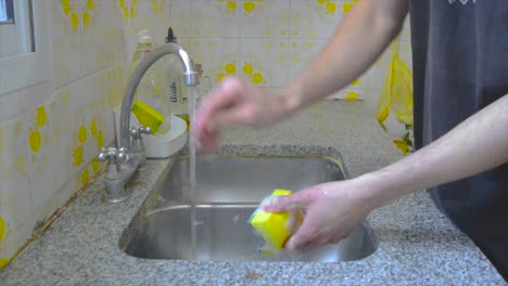 Male-person-doing-dishes-at-home