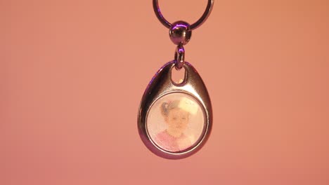 Close-Up-of-the-Hanging-Child's-Photo-in-Metal-Souvenir-Keychain
