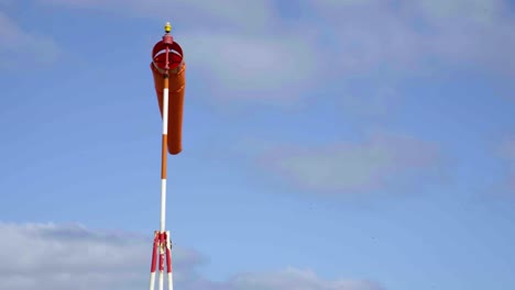 A-windsock-blowing-next-to-an-airport