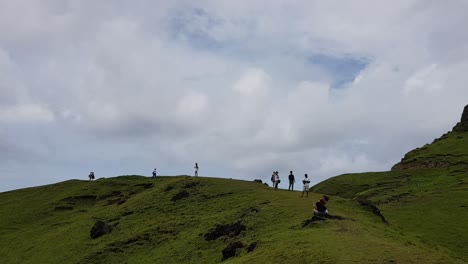 Group-of-tourists-walking-on-top-of-a-hill-and-taking-photos