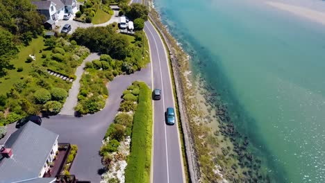 Aerial-footage-of-car-driving-to-Inchydoney-Beach,-Ireland,-June-2017