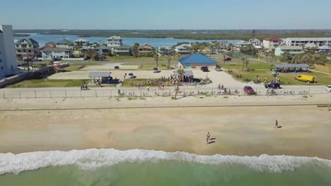 Drone-flight-near-a-Floridian-beach-with-tourists-and-hotels