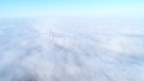 Flight-over-misty-clouds-in-morning-sunlight-with-little-glory-and-city-scape-under-clouds