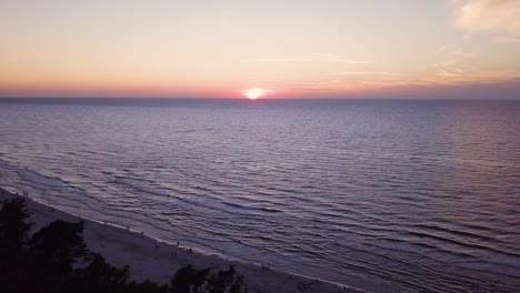 Drone-footage-of-a-sunset-over-Baltic-Sea,-Lubiatowo-Beach,-Poland